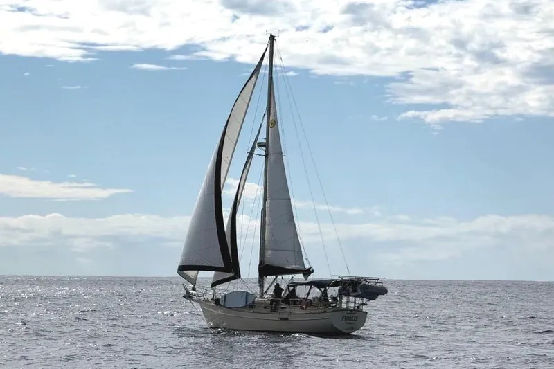 Slide: The Image of Sailing yacht Island Packet 35, 1990 model, cruising on open sea under clear skies. - 2