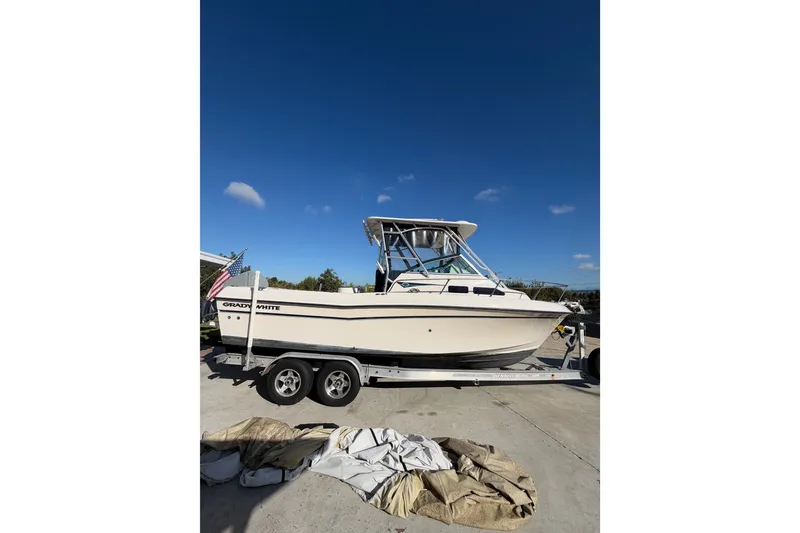 Slide: The Image of 2003 Grady-White Gulfstream 232 boat on trailer under clear blue sky. - 3