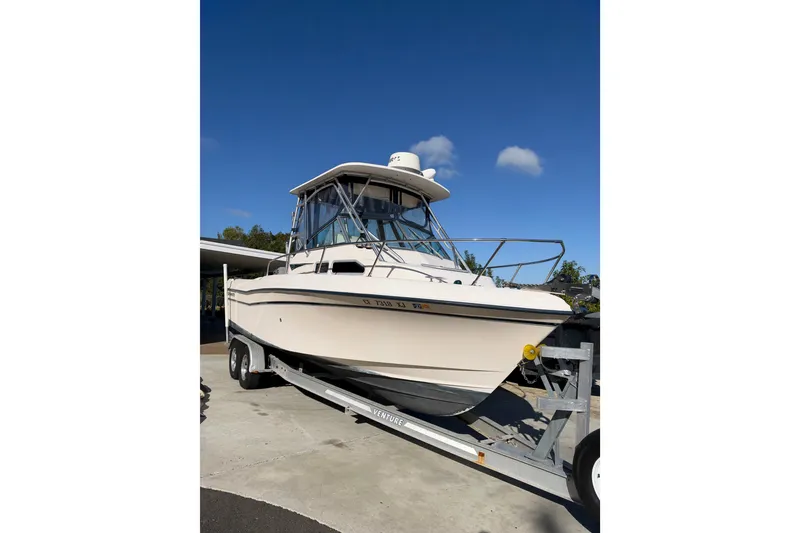 Slide: The Image of 2003 Grady-White Gulfstream 232 boat on trailer under clear blue sky. - 5