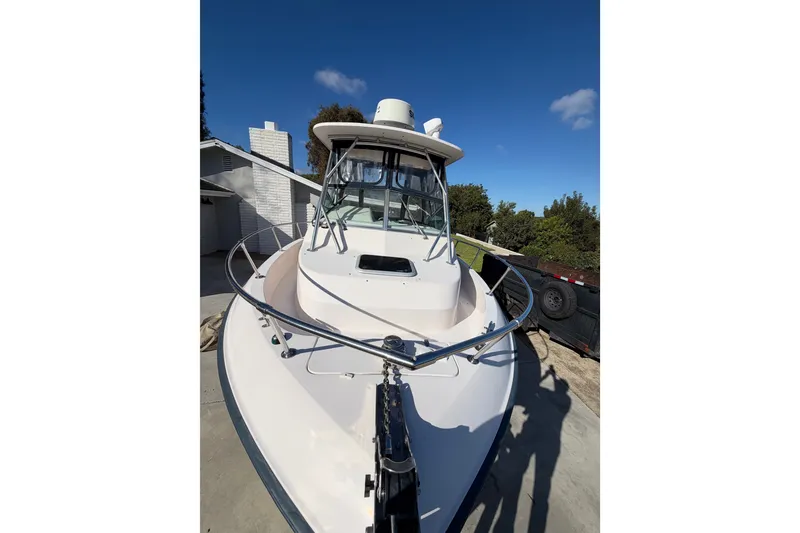 Slide: The Image of 2003 Grady-White Gulfstream 232 boat docked under clear blue sky. - 6