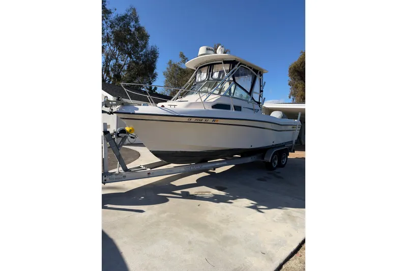 The Image of 2003 Grady-White Gulfstream 232 boat on trailer, parked outdoors. - 0