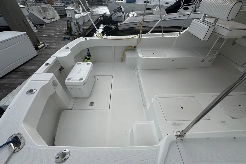 Slide: The Image of 2000 Mainship Pilot 30 boat deck with seating and storage at marina. - 14