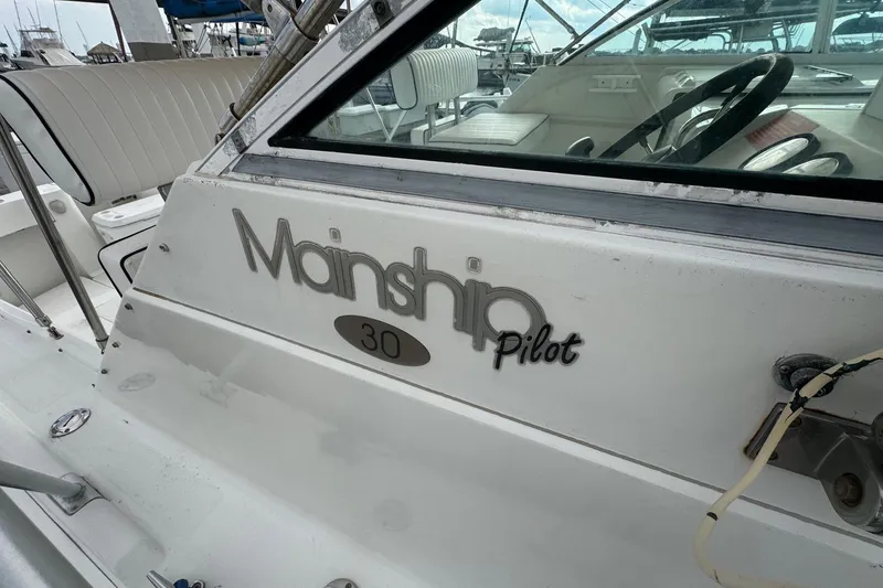 Slide: The Image of Mainship Pilot 30 boat, 2000 model, featuring cockpit and steering wheel. - 13