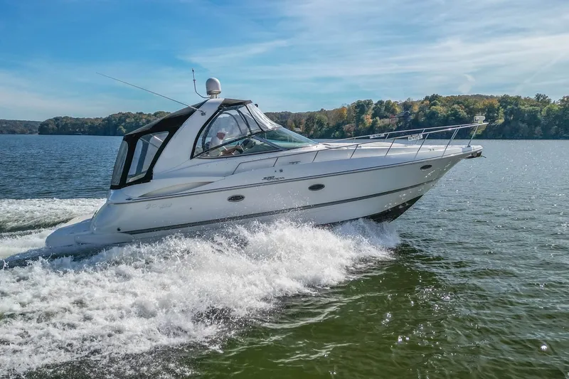 The Image of 2005 Cruisers Yachts 370 Express cruising on a scenic lake. - 1