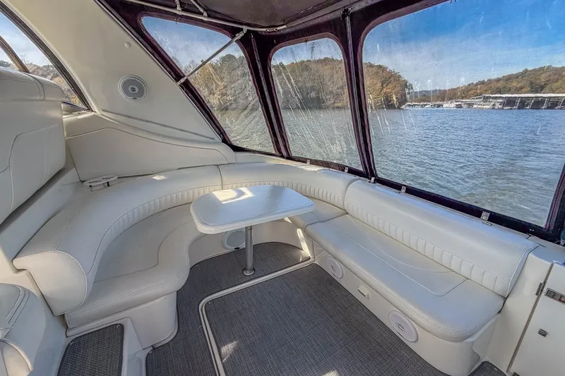 Slide: The Image of Interior of 2005 Cruisers Yachts 370 Express with white seating and lake view. - 16