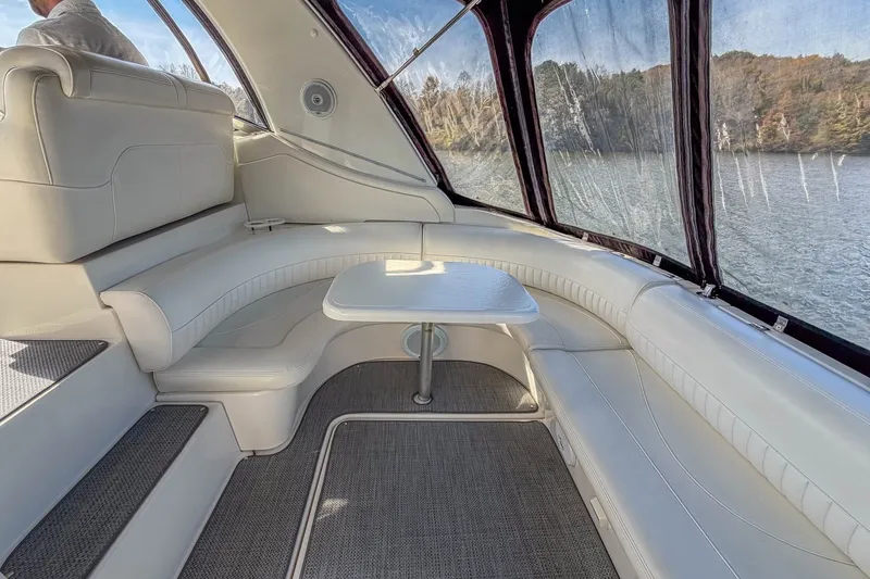Slide: The Image of Luxurious interior of 2005 Cruisers Yachts 370 Express with white seating and table. - 17
