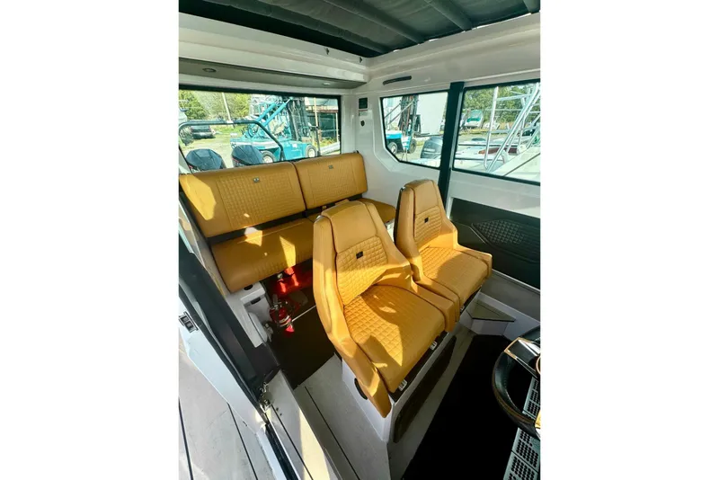 Slide: The Image of 2021 Axopar Brabus 28 Cabin interior with luxurious tan seating and modern design. - 21