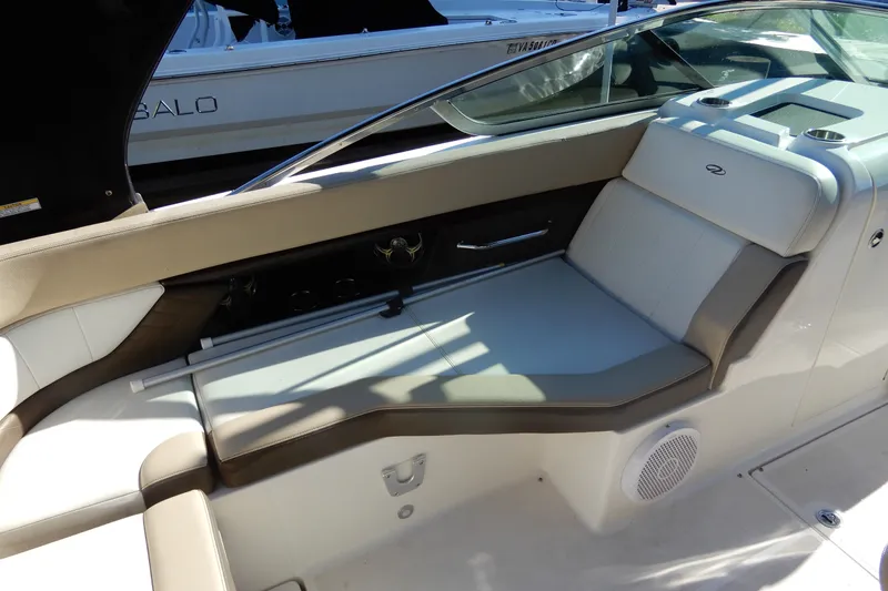 Slide: The Image of Interior seating of a 2013 Regal 24 FasDeck boat, featuring beige and white upholstery. - 7