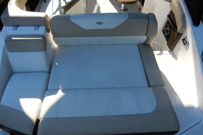 Slide: The Image of 2013 Regal 24 FasDeck boat interior with beige and white seating. - 3