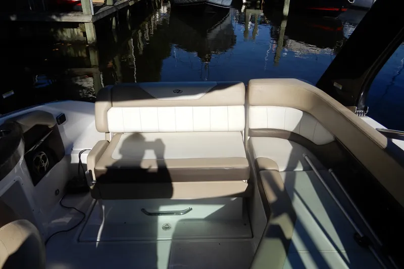 Slide: The Image of 2013 Regal 24 FasDeck boat interior with beige and white seating. - 6