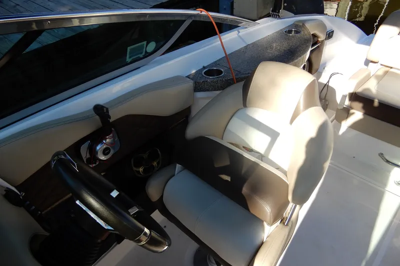 Slide: The Image of Interior of a 2013 Regal 24 FasDeck boat, featuring steering wheel and seating. - 9