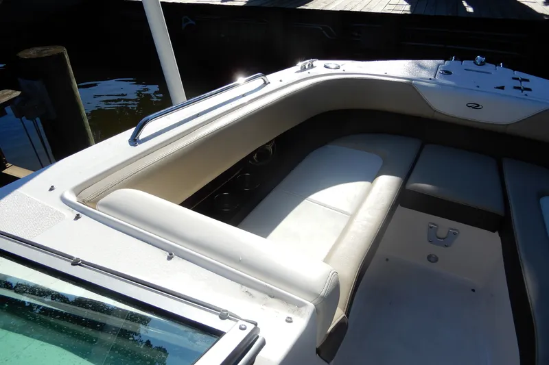 Slide: The Image of Interior view of a 2013 Regal 24 FasDeck boat with cushioned seating. - 14
