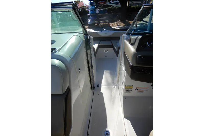 Slide: The Image of 2013 Regal 24 FasDeck boat interior with seating and dashboard view. - 13