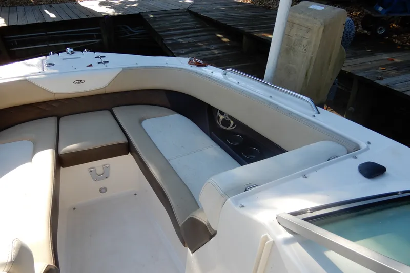 Slide: The Image of 2013 Regal 24 FasDeck boat interior with cushioned seating and control panel. - 18