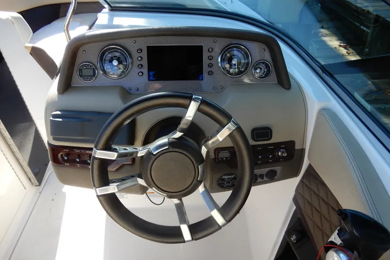 Slide: The Image of Steering console of 2013 Regal 24 FasDeck boat with gauges and controls. - 10