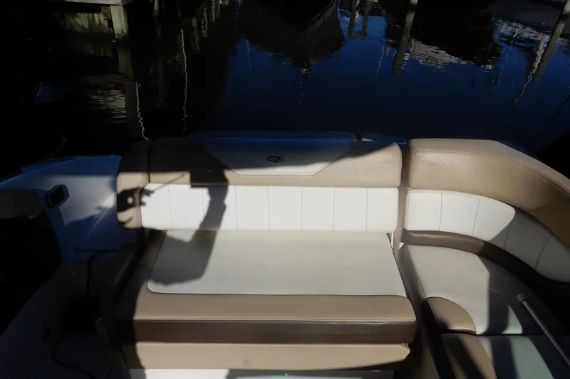 Slide: The Image of 2013 Regal 24 FasDeck boat interior with beige and white seating. - 5