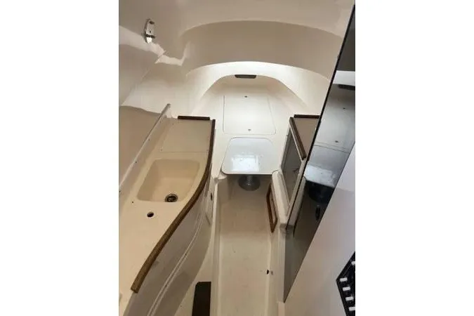 Slide: The Image of 2004 Contender 31 Fisharound cabin interior with sink and seating area. - 5