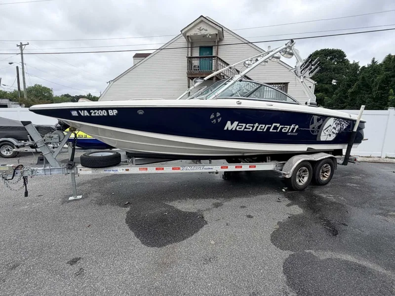 The Image of A 2008 MasterCraft X-45 boat on a trailer, parked in a lot. - 0
