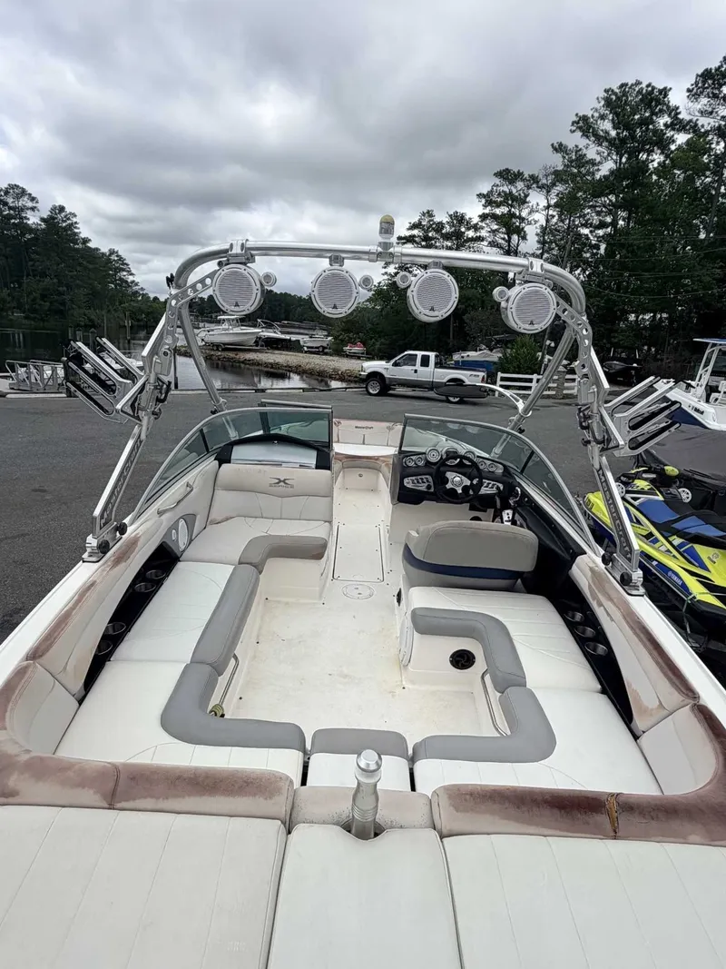 Slide: The Image of The image shows a 2008 MasterCraft X-45 boat with a spacious seating area and speakers. - 2