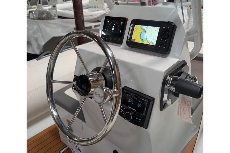Slide: The Image of Manufacturer Provided Image: Steering console of 2027 Tide Craft Coronado 14 with navigation and control systems. - 1