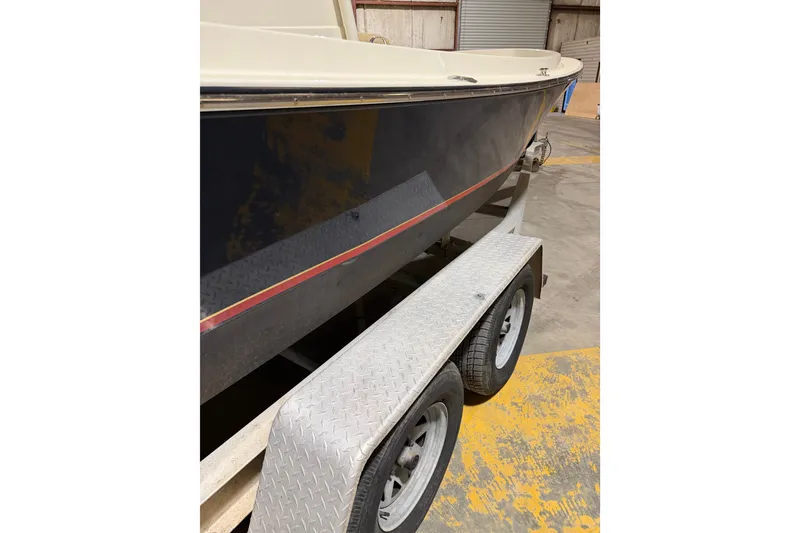 Slide: The Image of 1982 Shamrock 170 Center Console boat on trailer in warehouse. - 12