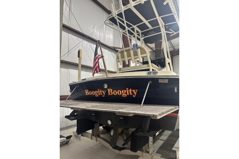 Slide: The Image of 1982 Shamrock 170 Center Console boat named "Boogity Boogity" in storage with American flag. - 2
