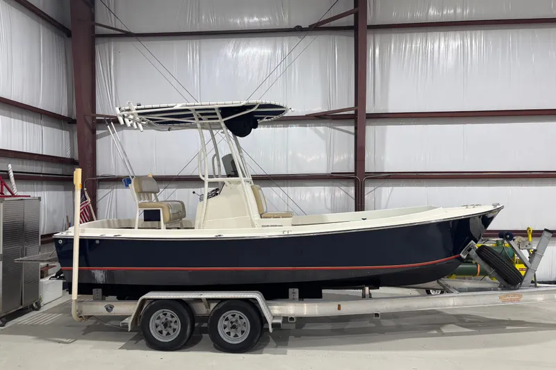 Slide: The Image of 1982 Shamrock 170 Center Console boat on trailer in indoor storage. - 1
