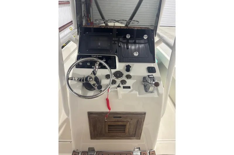 Slide: The Image of 1982 Shamrock 200 Open boat dashboard with steering wheel and controls. - 9