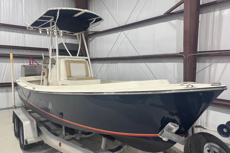 Slide: The Image of 1982 Shamrock 200 Open boat on trailer in indoor storage facility. - 12