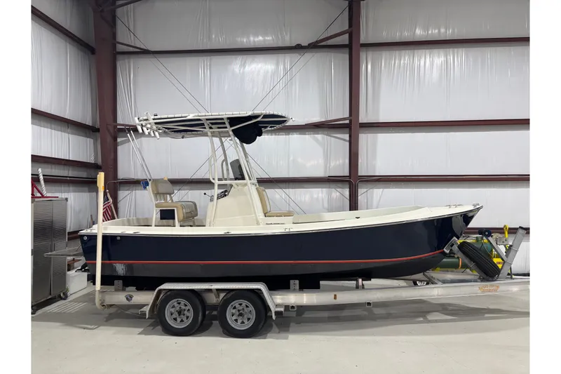 Slide: The Image of 1982 Shamrock 200 Open boat on trailer in indoor storage facility. - 1