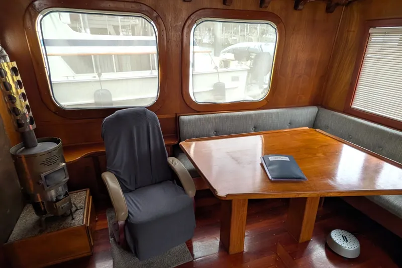 Slide: The Image of Interior of 1981 Custom 43 Pilothouse Trawler with wood table and seating area. - 34