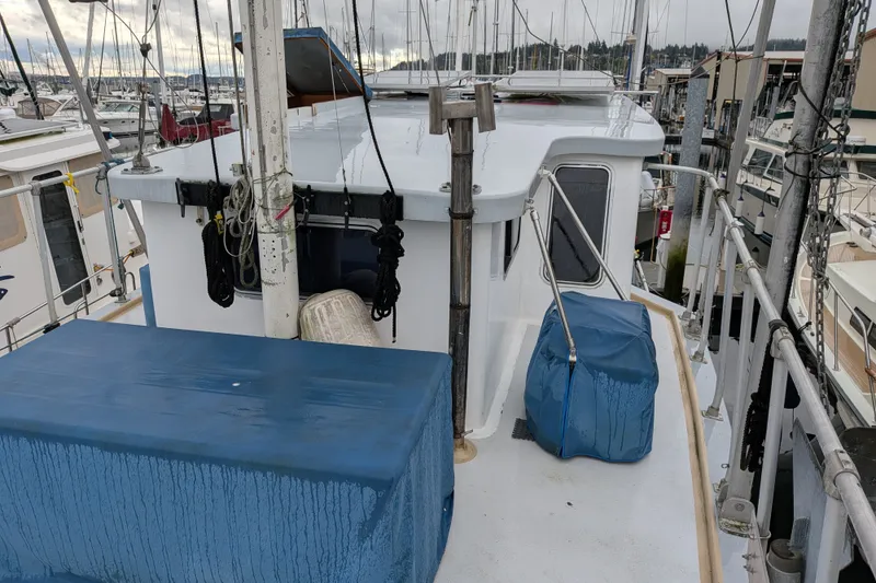 Slide: The Image of 1981 Custom 43 Pilothouse Trawler docked, featuring deck and pilothouse view. - 17