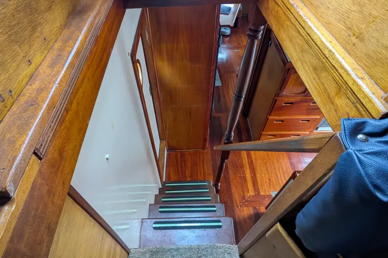 Slide: The Image of Interior view of 1981 Custom 43 Pilothouse Trawler, showcasing wooden stairs and cabin. - 64