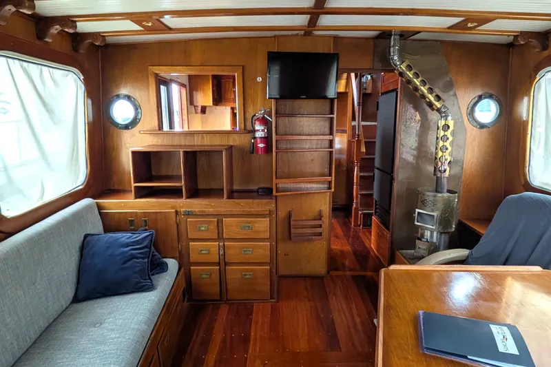 Slide: The Image of Interior of 1981 Custom 43 Pilothouse Trawler with wood paneling and cozy furnishings. - 35