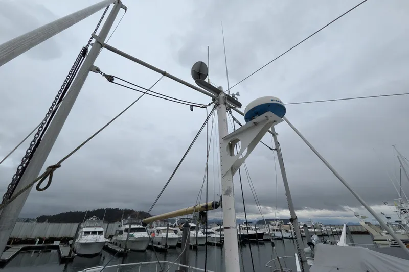 Slide: The Image of Mast and rigging of 1981 Custom 43 Pilothouse Trawler at marina under cloudy sky. - 20
