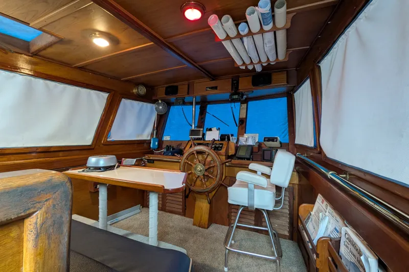 Slide: The Image of Interior of 1981 Custom 43 Pilothouse Trawler with wooden helm and navigation equipment. - 56