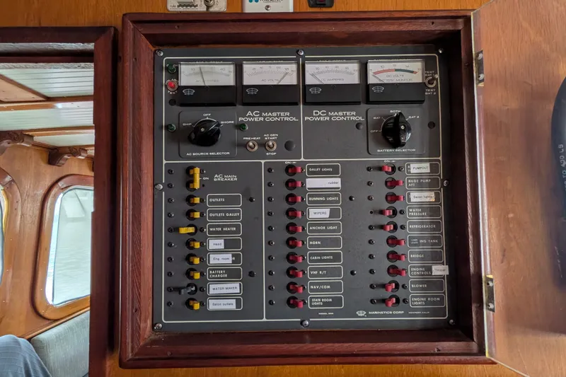 Slide: The Image of Electrical control panel on 1981 Custom 43 Pilothouse Trawler, featuring AC and DC power controls. - 65