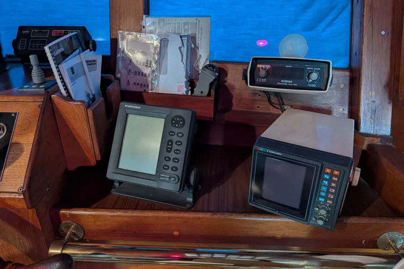 Slide: The Image of Pilothouse electronics on 1981 Custom 43 Pilothouse Trawler, featuring navigation and communication devices. - 58