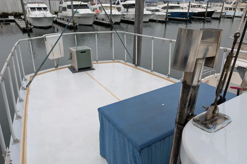 Slide: The Image of 1981 Custom 43 Pilothouse Trawler deck at marina with surrounding boats. - 18