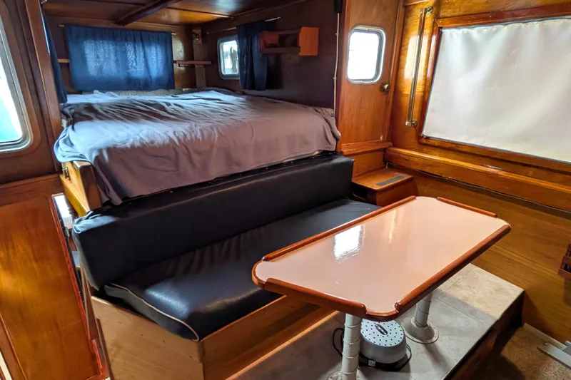 Slide: The Image of Interior of 1981 Custom 43 Pilothouse Trawler with bed, seating, and table. - 63