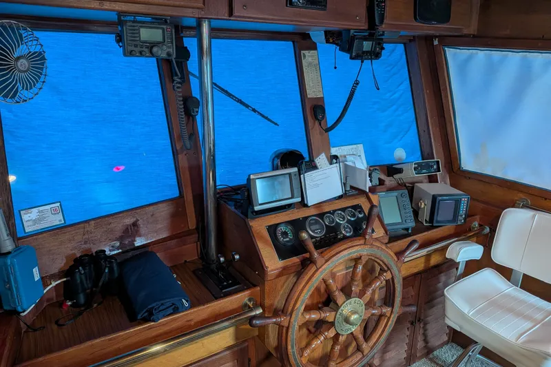 Slide: The Image of Pilothouse interior of 1981 Custom 43 Pilothouse Trawler with navigation equipment and wooden steering wheel. - 61