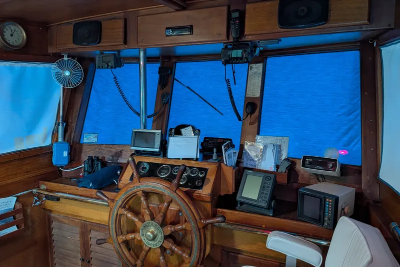 Slide: The Image of Pilothouse interior of 1981 Custom 43 Pilothouse Trawler with wooden wheel and navigation equipment. - 57