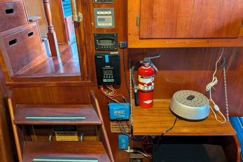 Slide: The Image of Interior of 1981 Custom 43 Pilothouse Trawler with fire extinguisher and electronic equipment. - 48