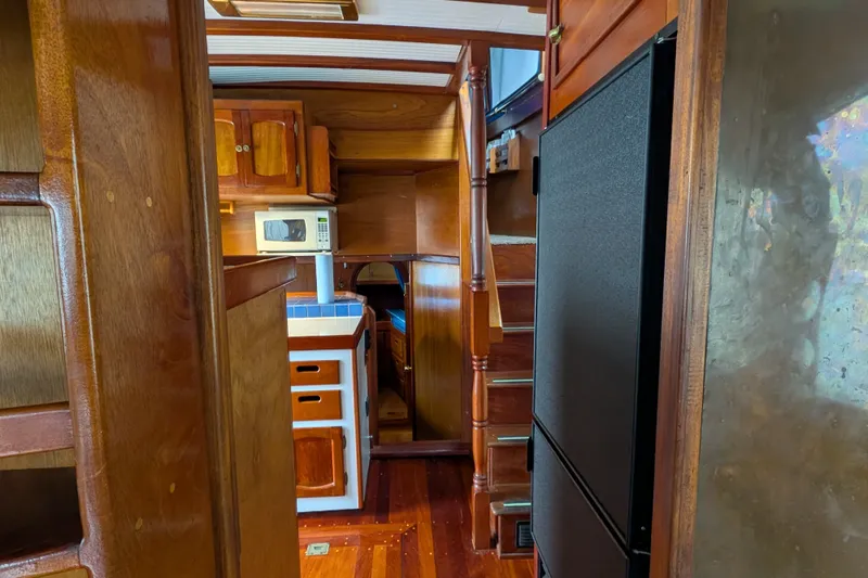 Slide: The Image of Interior of 1981 Custom 43 Pilothouse Trawler with wooden cabinetry and modern appliances. - 41