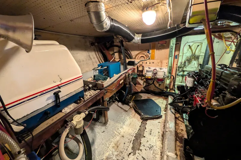 Slide: The Image of Engine room of a 1981 Custom 43 Pilothouse Trawler, showcasing machinery and equipment. - 68