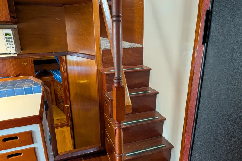 Slide: The Image of Interior of 1981 Custom 43 Pilothouse Trawler with wooden stairs and cabinetry. - 53