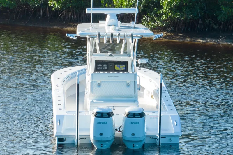 Slide: The Image of 2023 SeaHunter 28 Floridian boat on calm water, featuring dual 300 horsepower engines. - 22