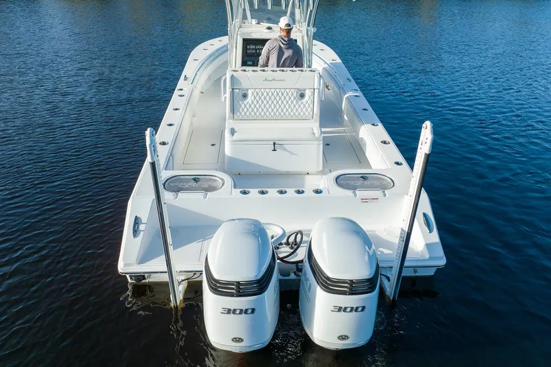 Slide: The Image of 2023 SeaHunter 28 Floridian boat with dual engines on calm water. - 15
