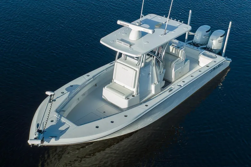 Slide: The Image of 2023 SeaHunter 28 Floridian boat on calm water, featuring dual engines and sleek design. - 16