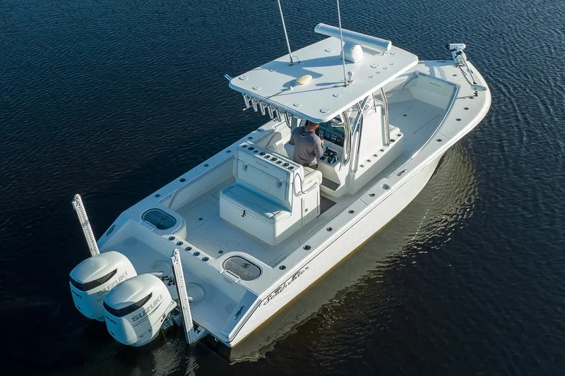 Slide: The Image of 2023 SeaHunter 28 Floridian boat on water, featuring dual engines and spacious deck. - 18